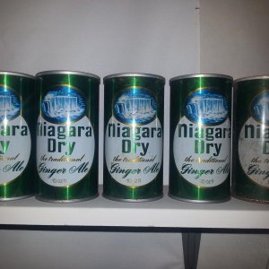 5 Niagara Dry cans. The one on the left has a different opening.
