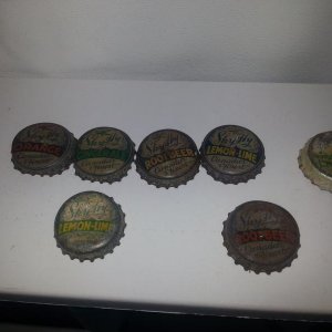 A collection of Sky-Hy bottle caps with two Lemon-Lime variants, and two Root Beer variants (different coloration of "ROOT BEER").

Also pictured is a Niagara Lemon-Lime Rickey bottle cap. Niagara LLR was also produced by Niagara Dry Beverages, but I've not seen any Niagara LLR bottles.