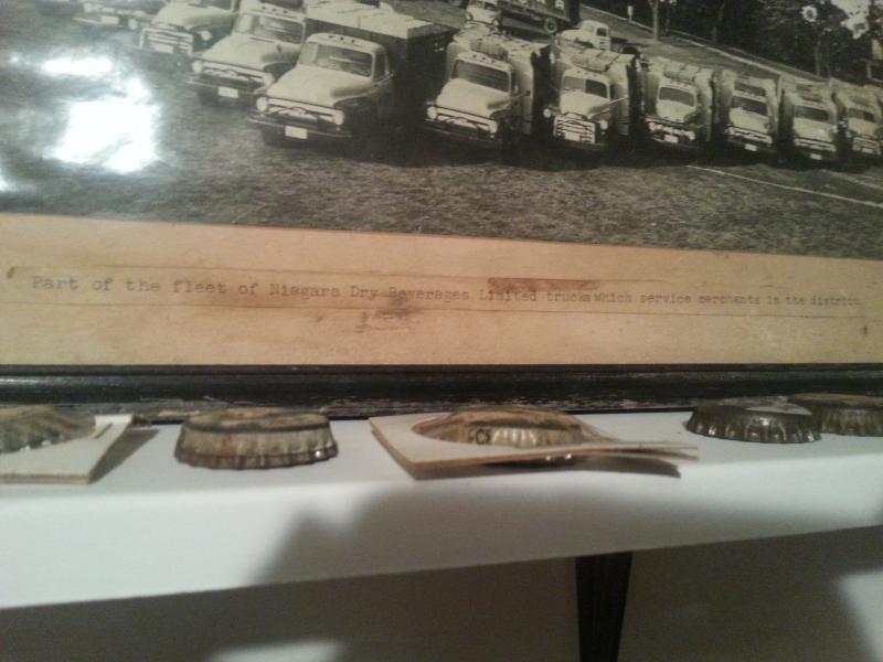 Close-up of the photograph description; "Part of the fleet of Niagara Dry Beverages Limited trucks which service merchants in the district"