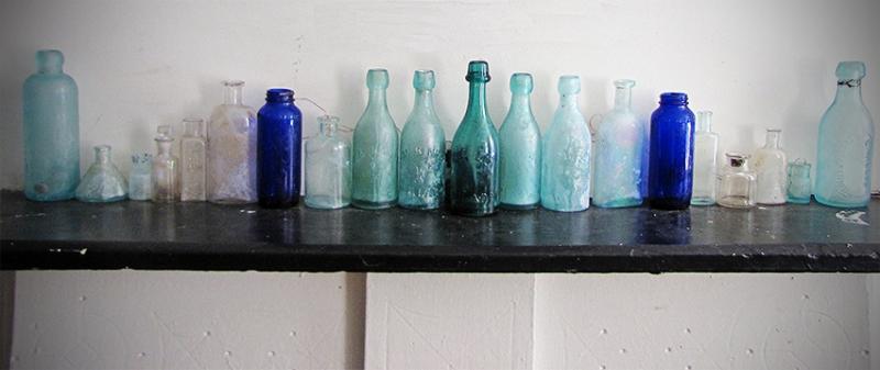 The mantle. An array of bottles and inks.