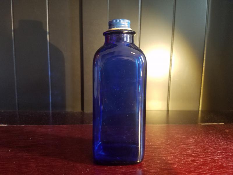 Unembossed cobalt rectangular bottle.