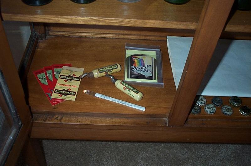 Various Niagara Dry products, including a matchbook, two bottle openers, original unused paper labels, 3 Cross of Honour slips and an unidentified white slim object.
