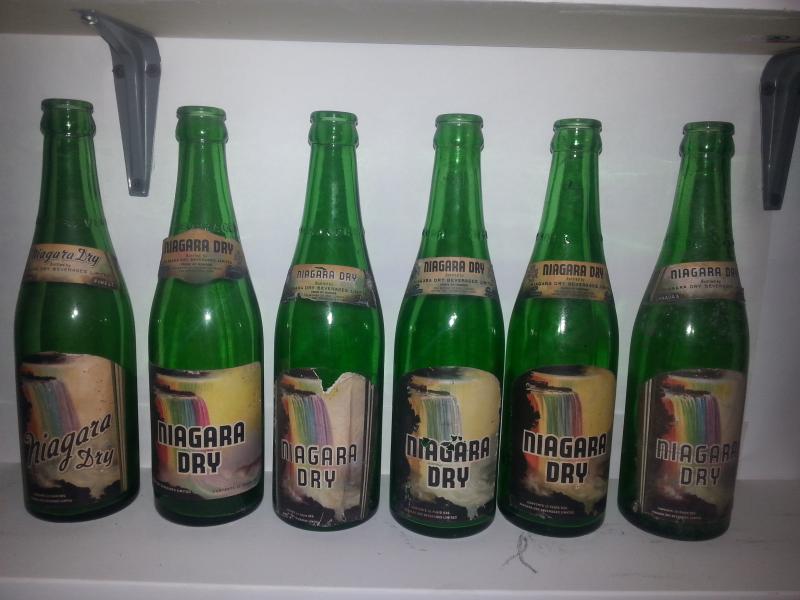 Various variations of Niagara Dry bottles with the rainbow falls labels.